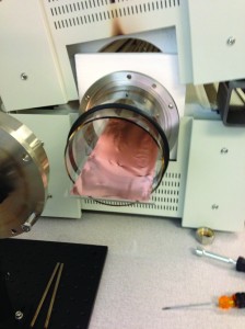 A sheet of copper being fed into the kiln during the chemical vapor deposition phase of graphene production. 